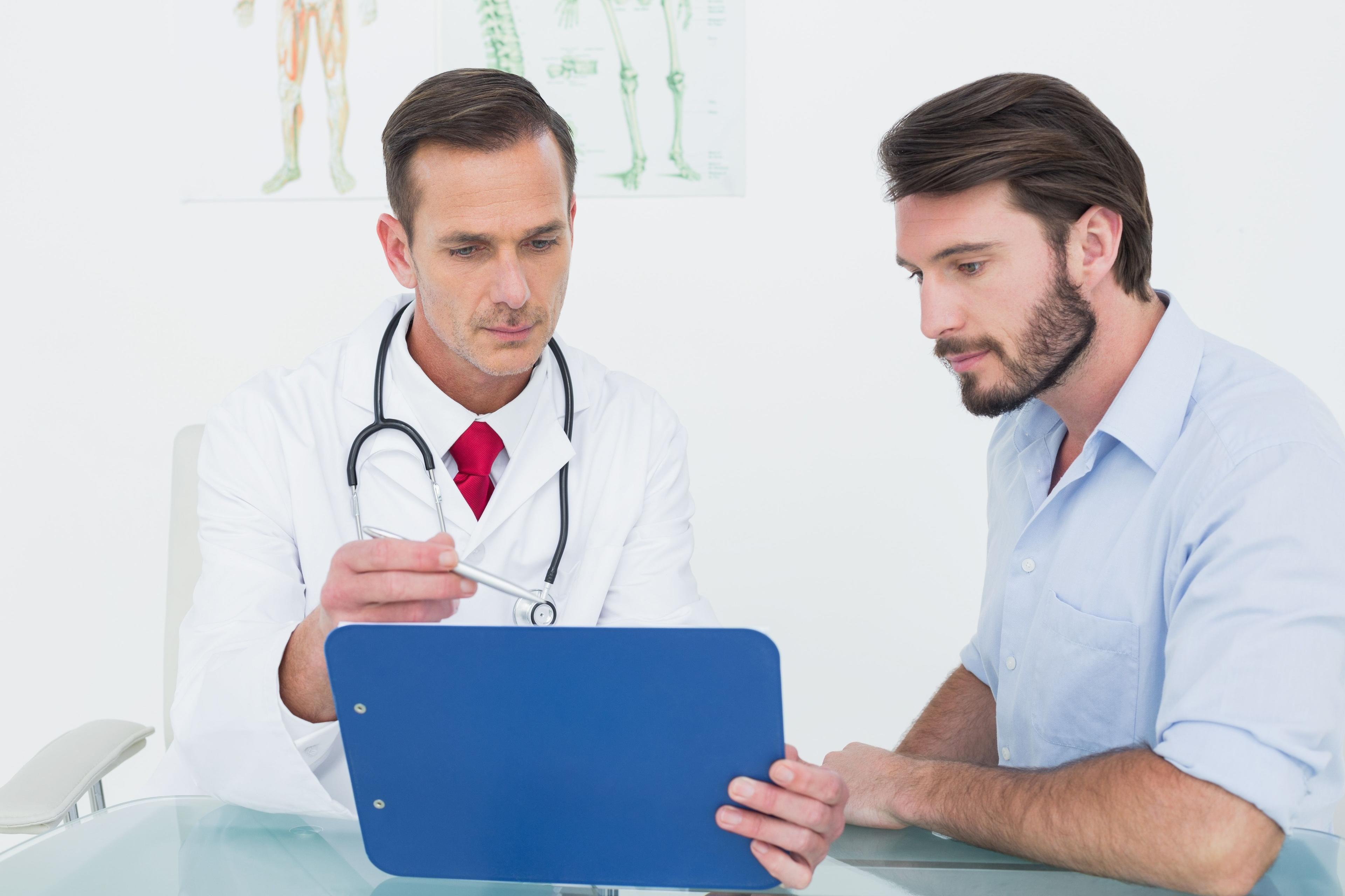 Doctor and patient discussing health data during a continuous condition monitoring session at Fanous Clinic in Charlotte NC, focusing on chronic disease management.