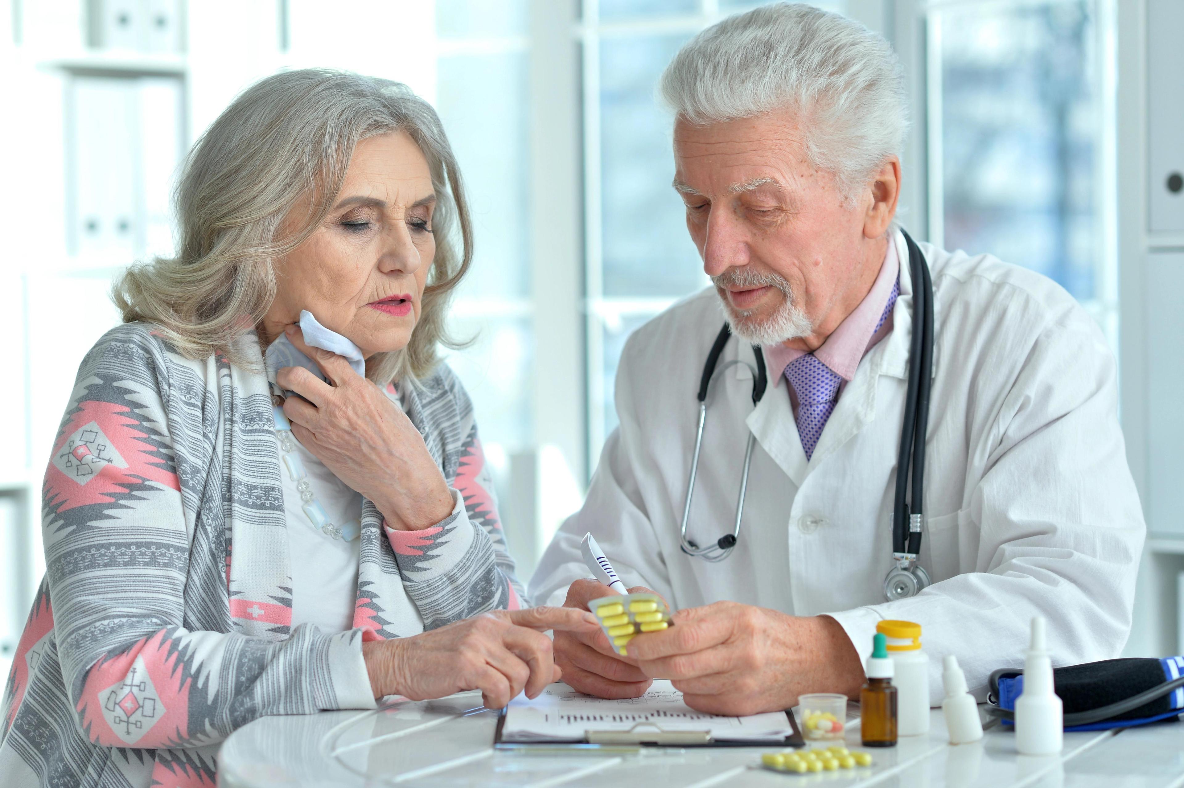 Senior doctor consulting with an elderly patient about her medications, focusing on a detailed medication assessment as part of the medication optimization services provided by a Primary Care Provider in Charlotte NC.